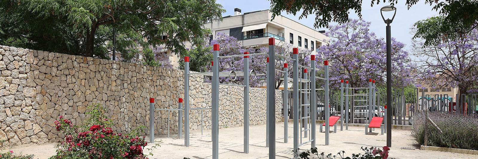 Wide shot of a fitness frame nestled among a residential recreational area.